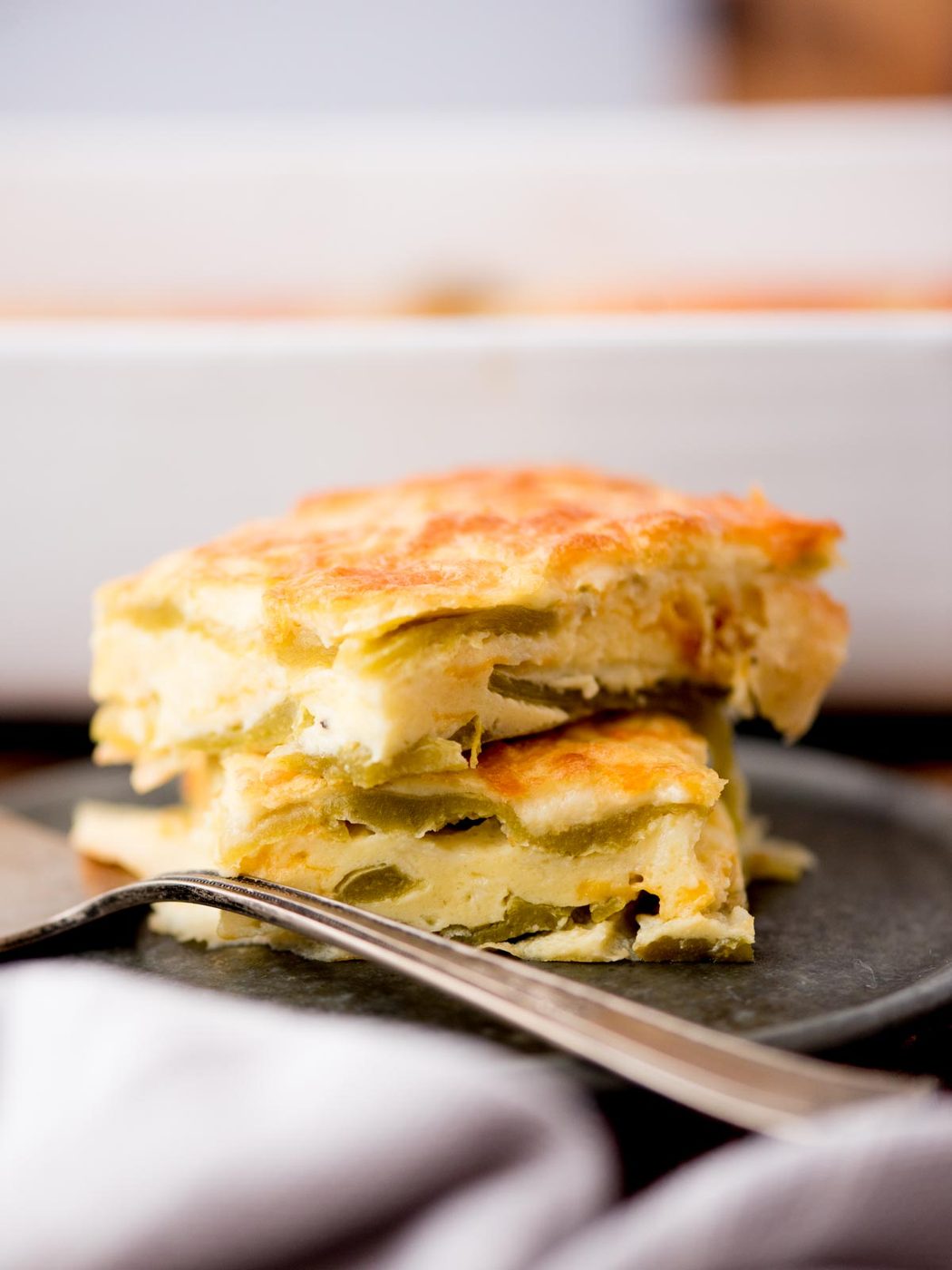 Two pieces of hatch chile relleno casserole served on a plate.