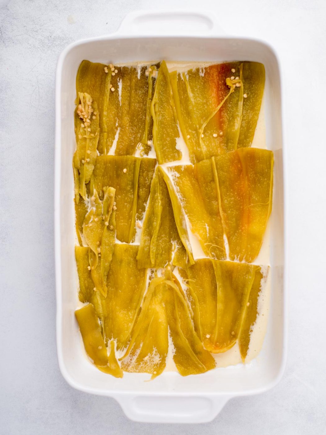 Hatch chiles added to the baking dish over egg mixture.