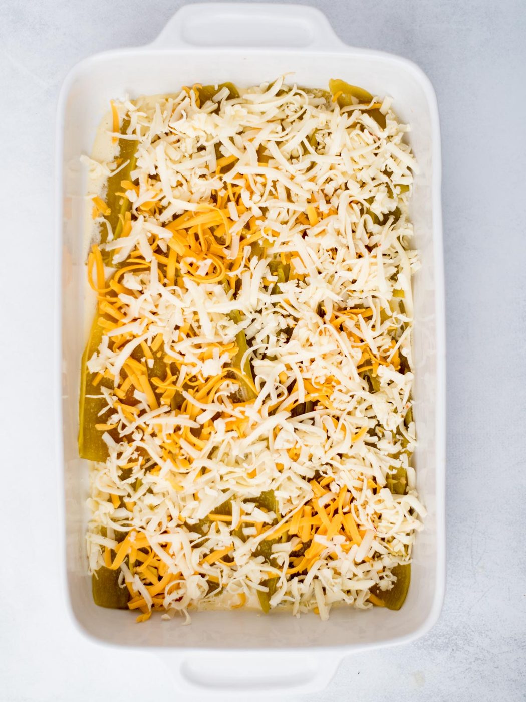 Shredded cheese added to the top of the hatch chiles.