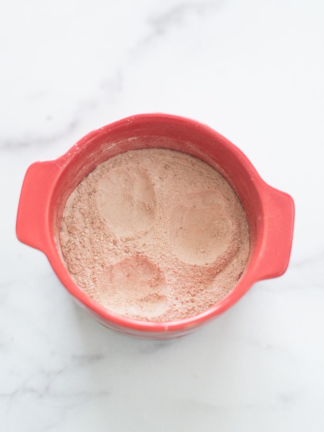 wells made in dry ingredients in mug