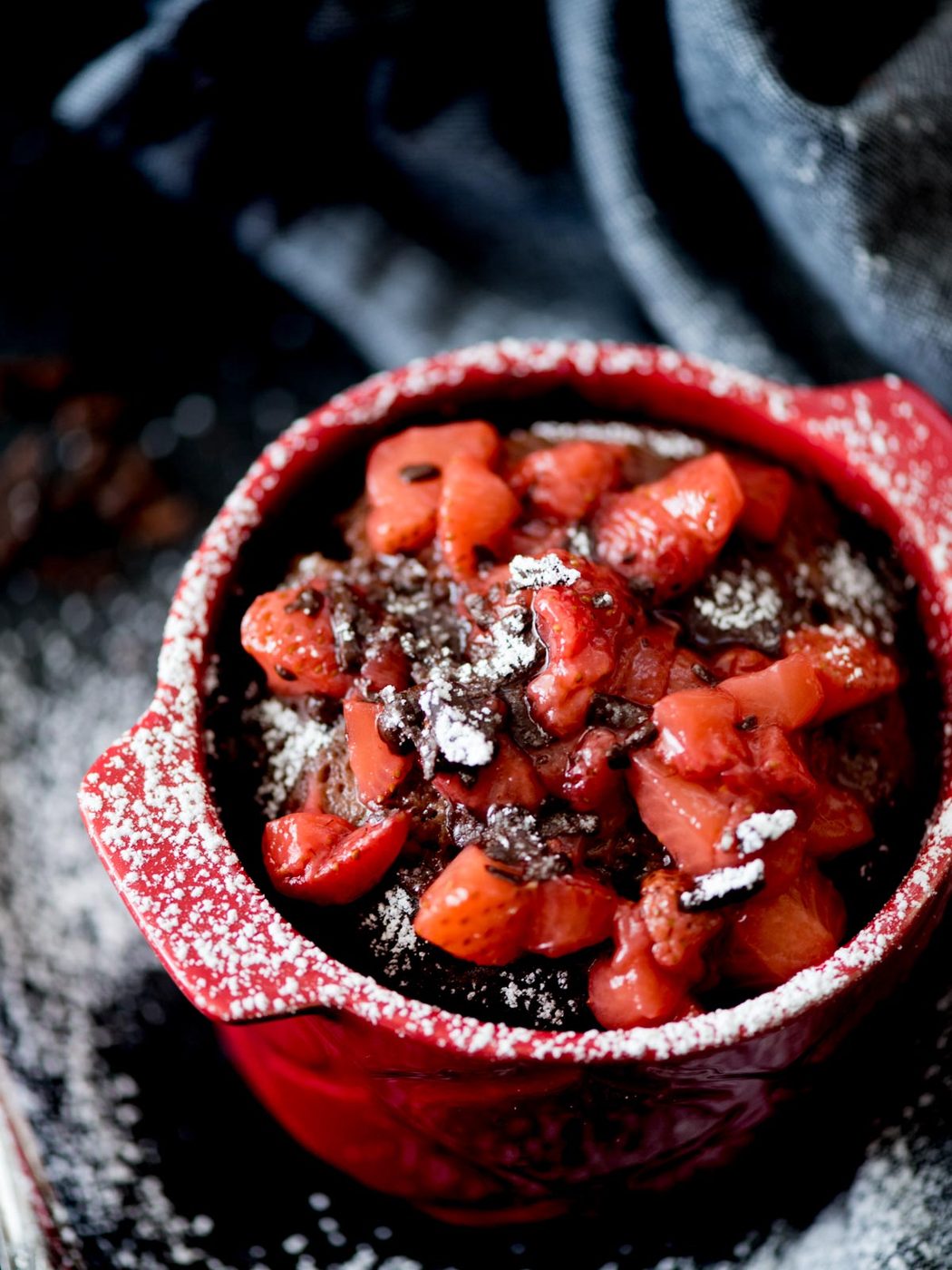Chocolate Mug Cake with Sweet Strawberry Topping and powdered sugar