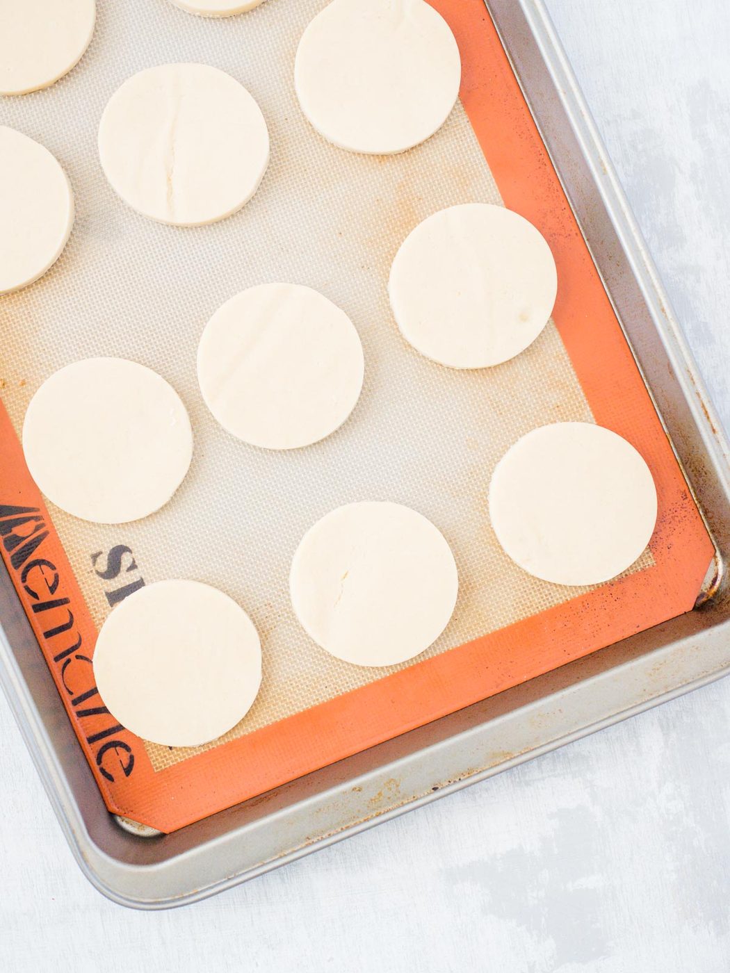 unbaked sugar cookies on a baking sheet