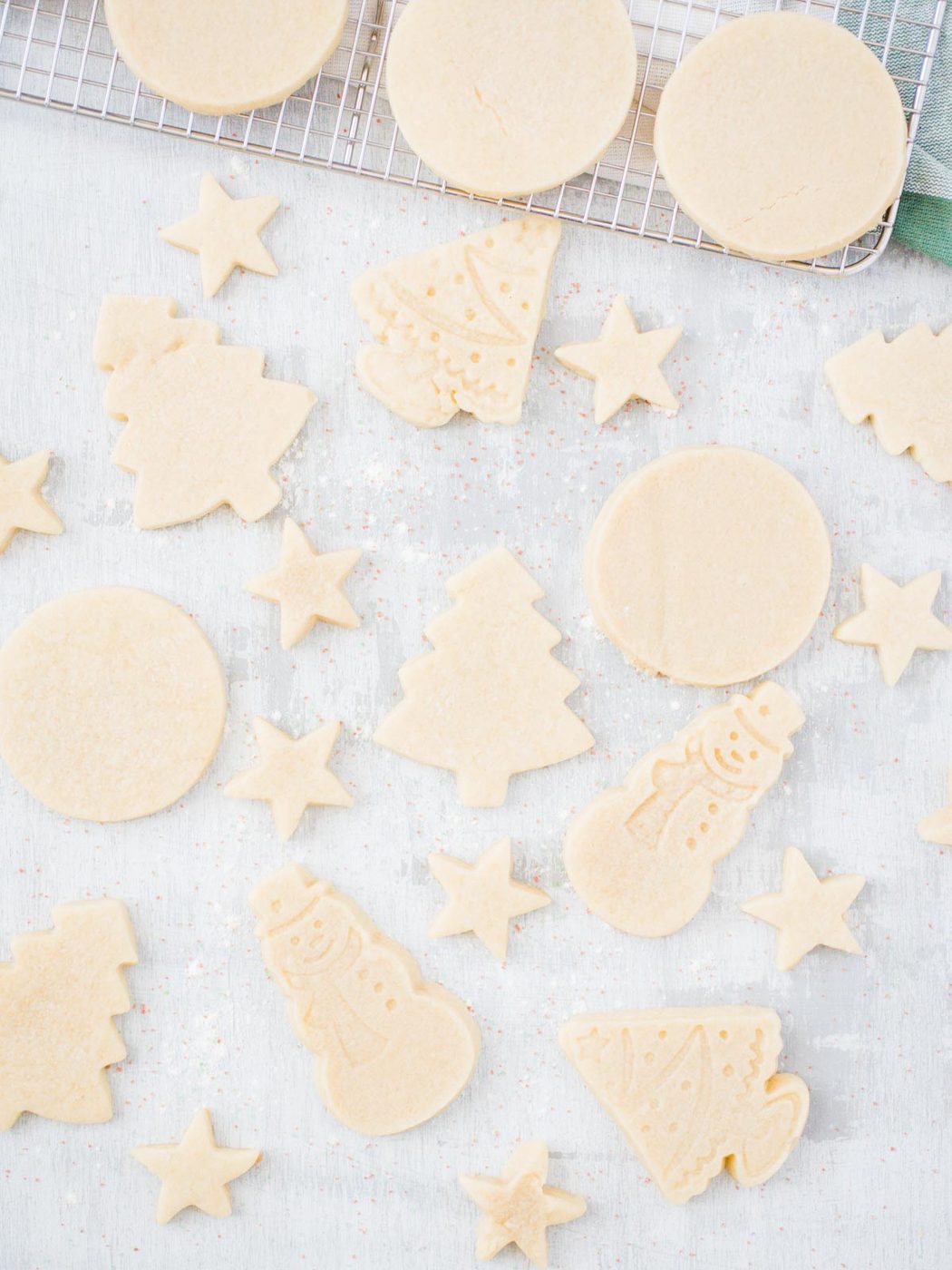 various sugar cookies including stars, snowmen, trees, and circles.