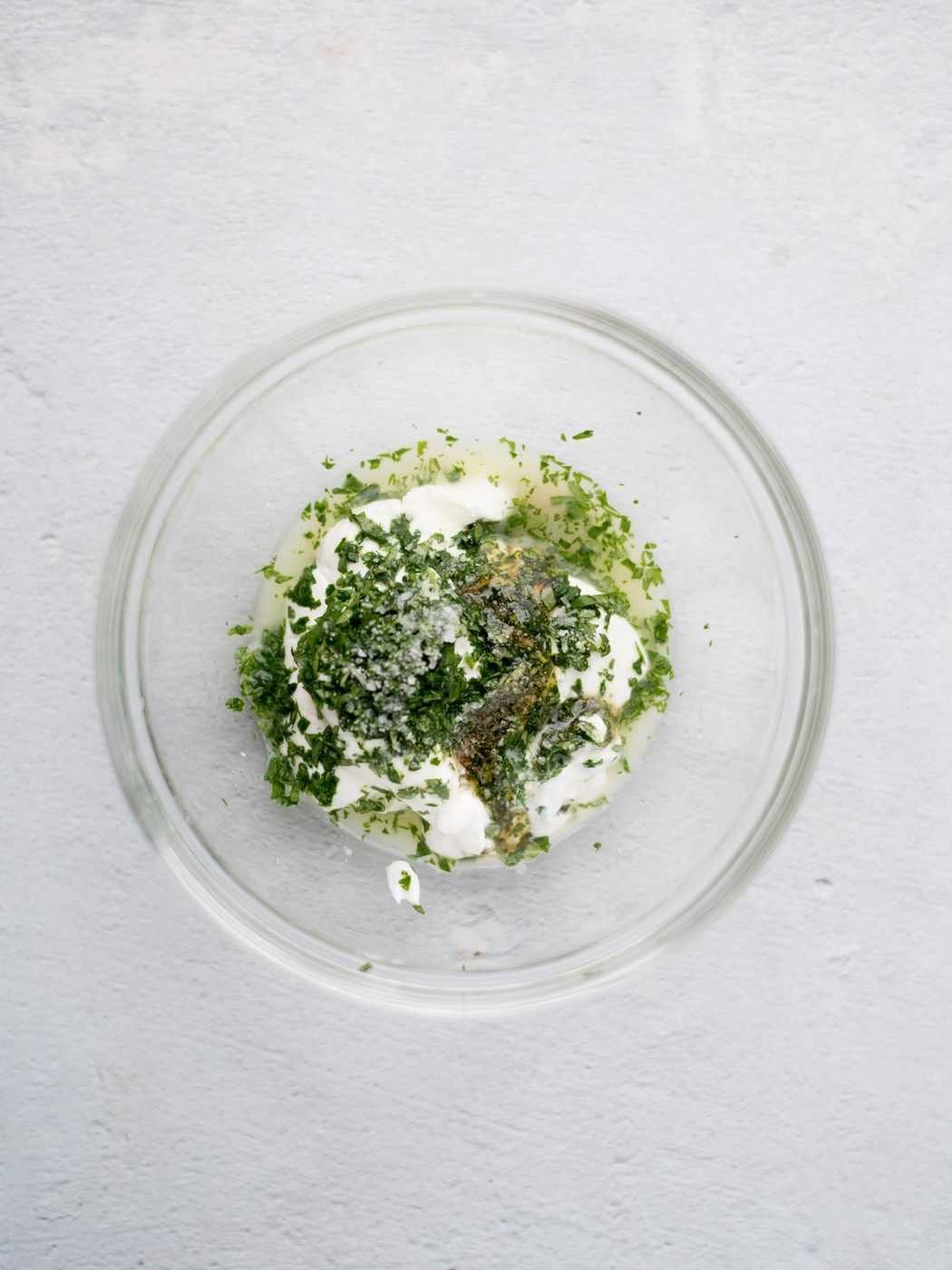 Ingredients for cilantro lime sauce added to a small mixing bowl.
