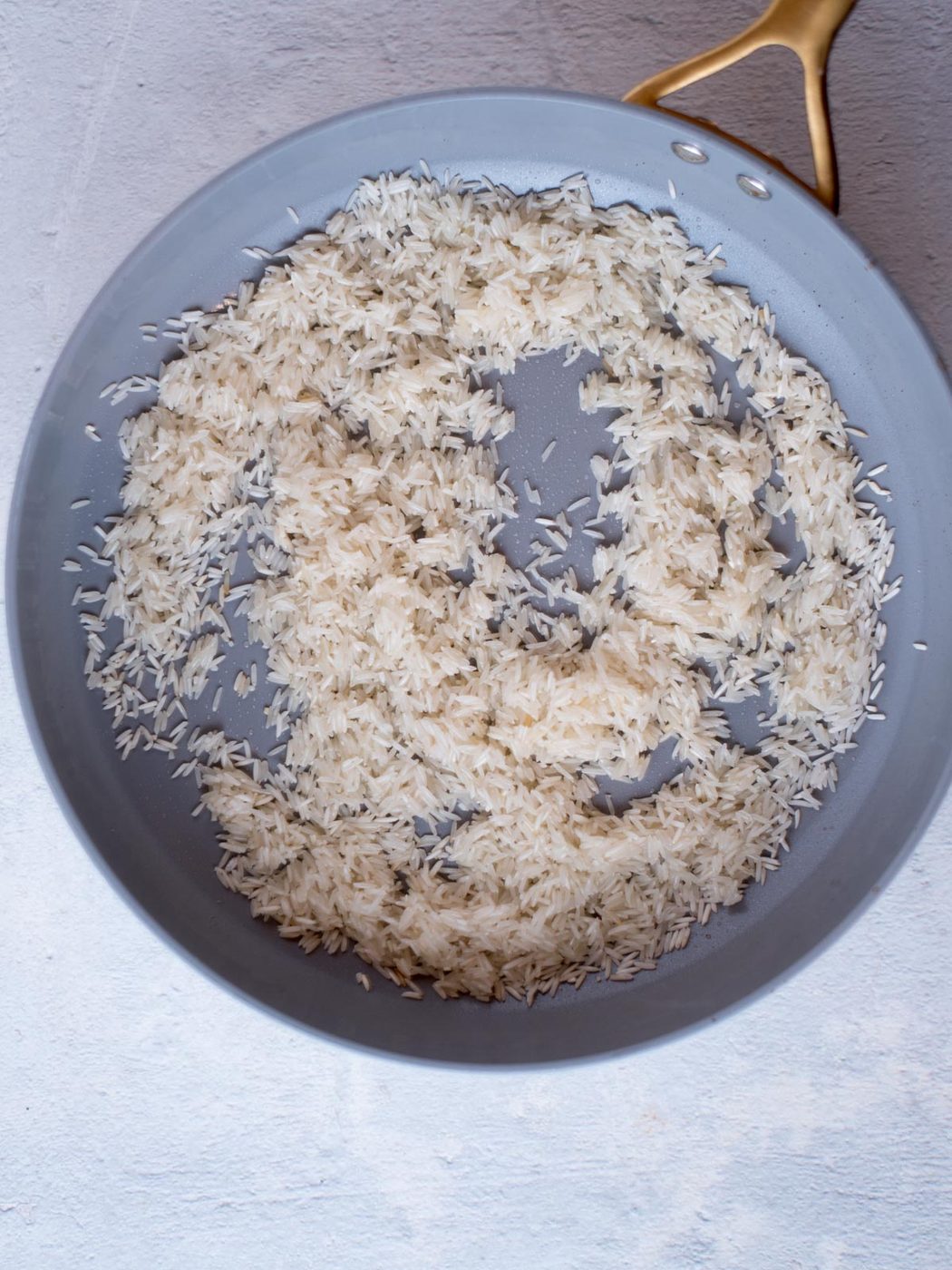 rice toasted in a skillet with butter, salt, and lime juice