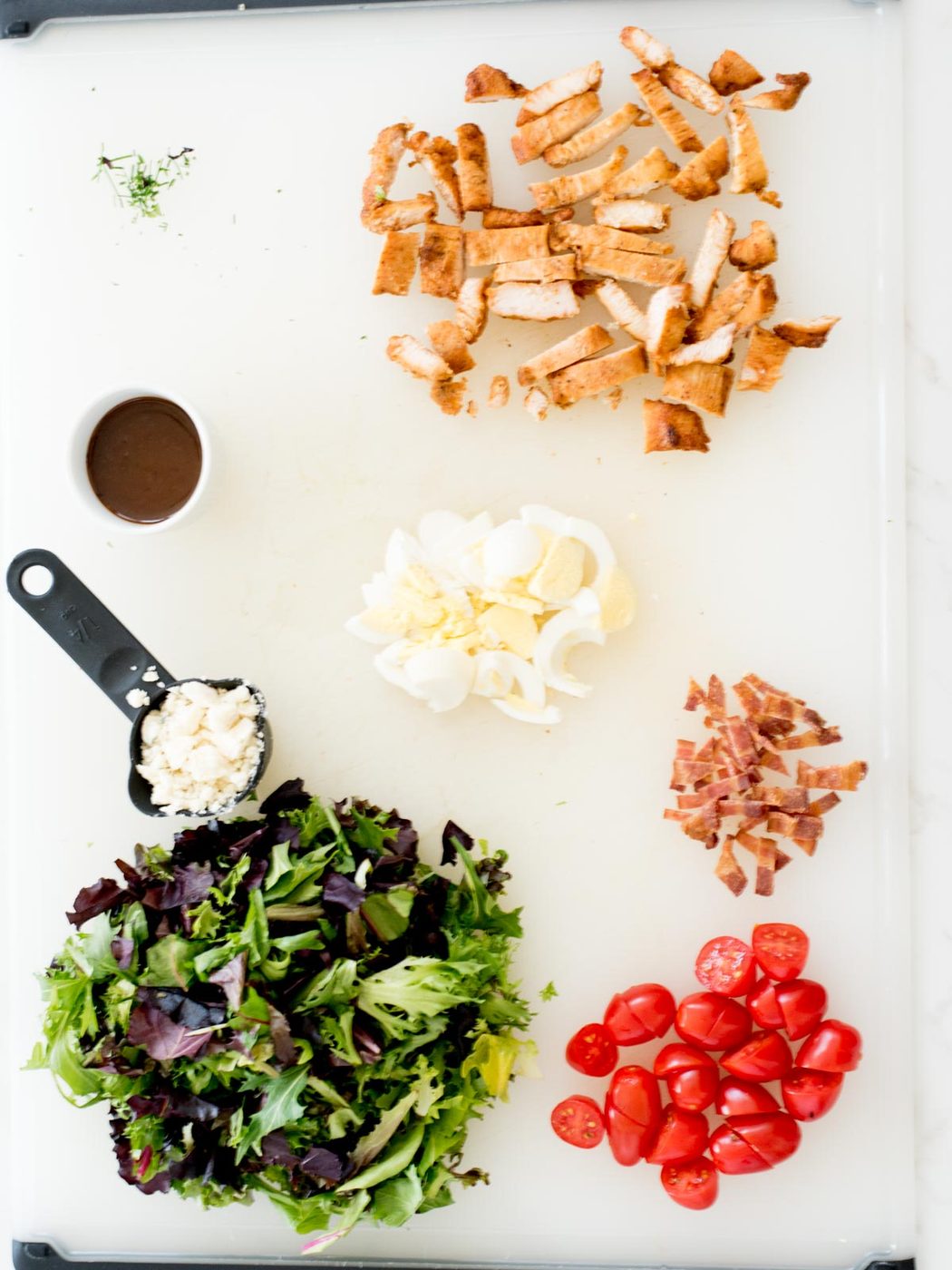 ingredients on a cutting board for cobb style mason jar salad