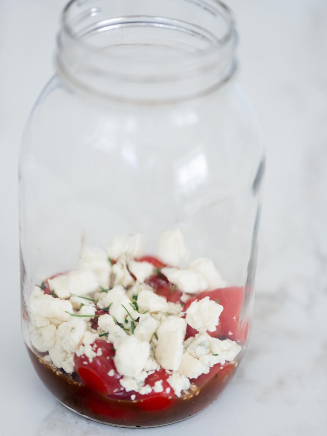 balsamic vinaigrette, tomatoes, gorgonzola, chives in a mason jar
