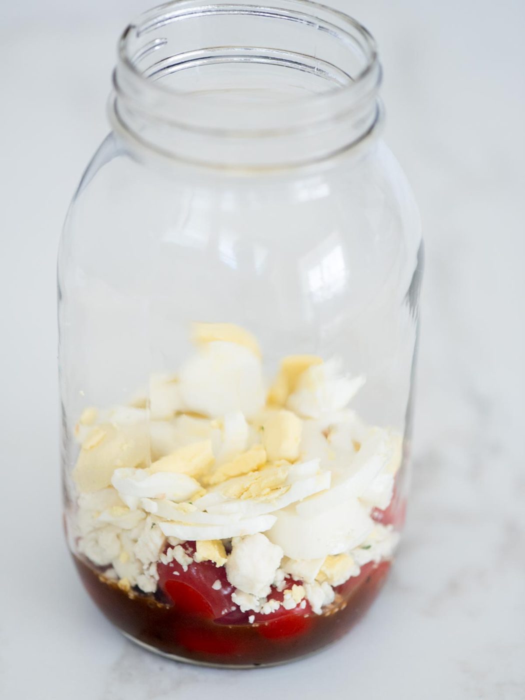 balsamic vinaigrette, tomatoes, gorgonzola, chives, egg in a mason jar