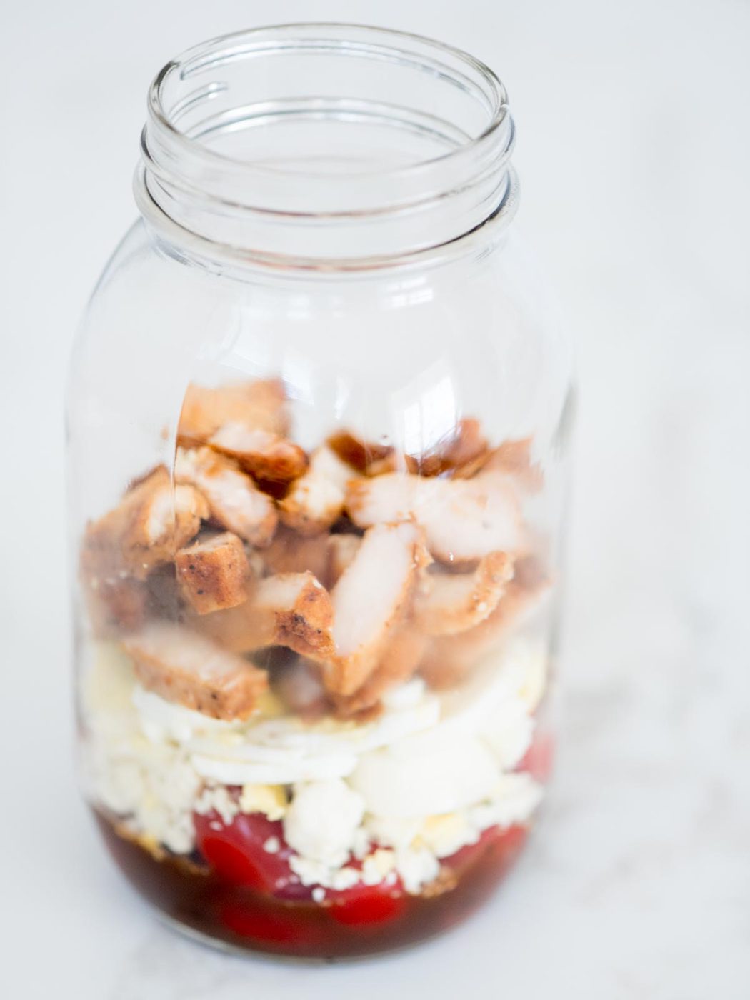 balsamic vinaigrette, tomatoes, gorgonzola, chives, egg, chicken in a mason jar