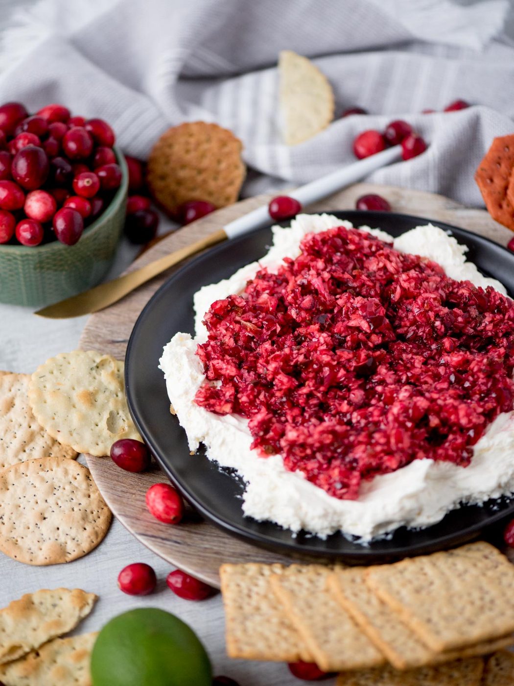 Cranberry jalapeno dip with cream cheese on a plate.
