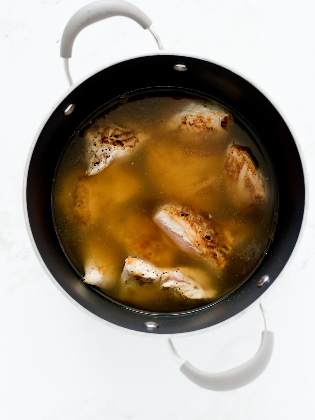 chicken and broth in soup pot