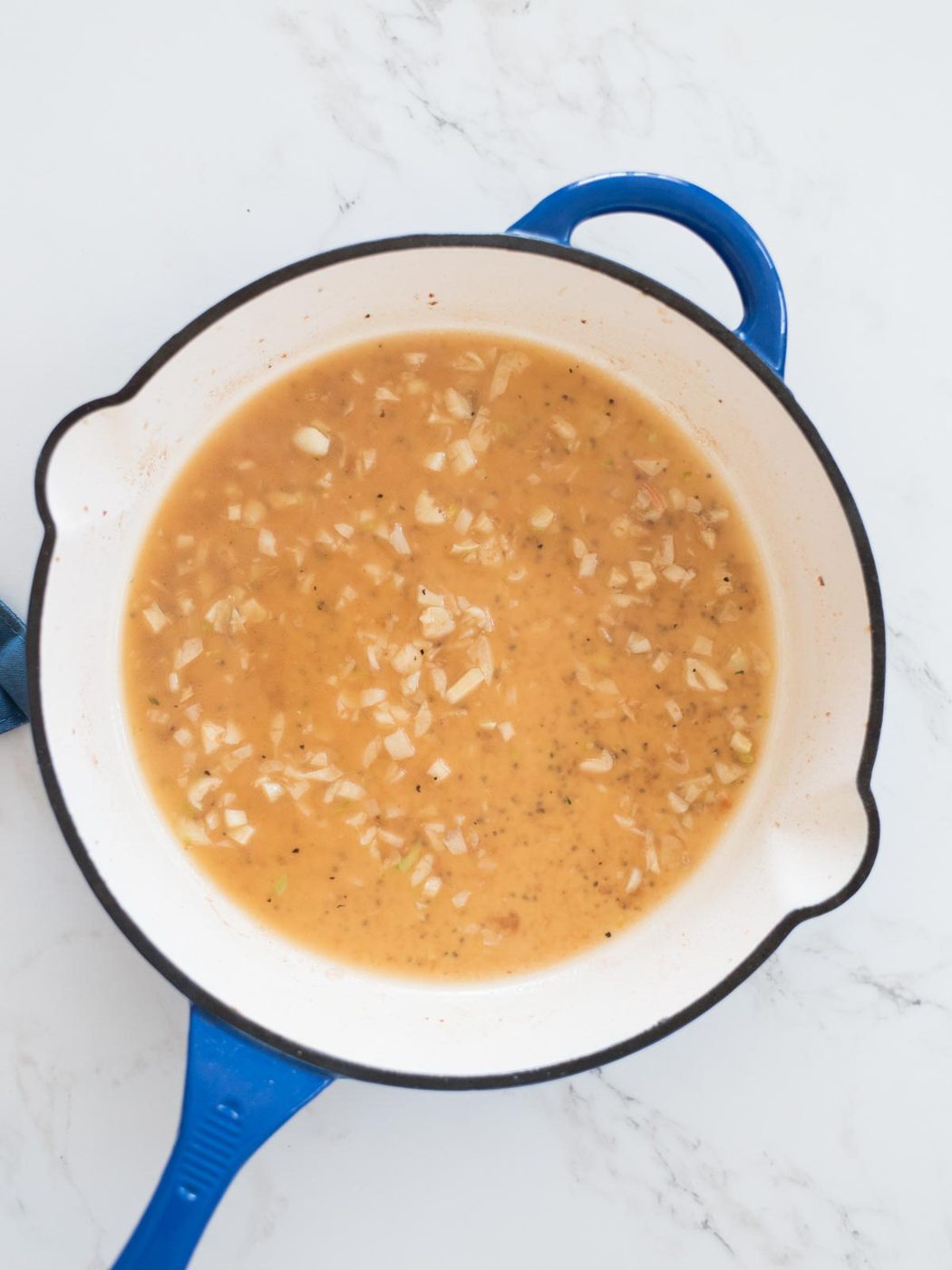 broth being added to de-glaze the skillet