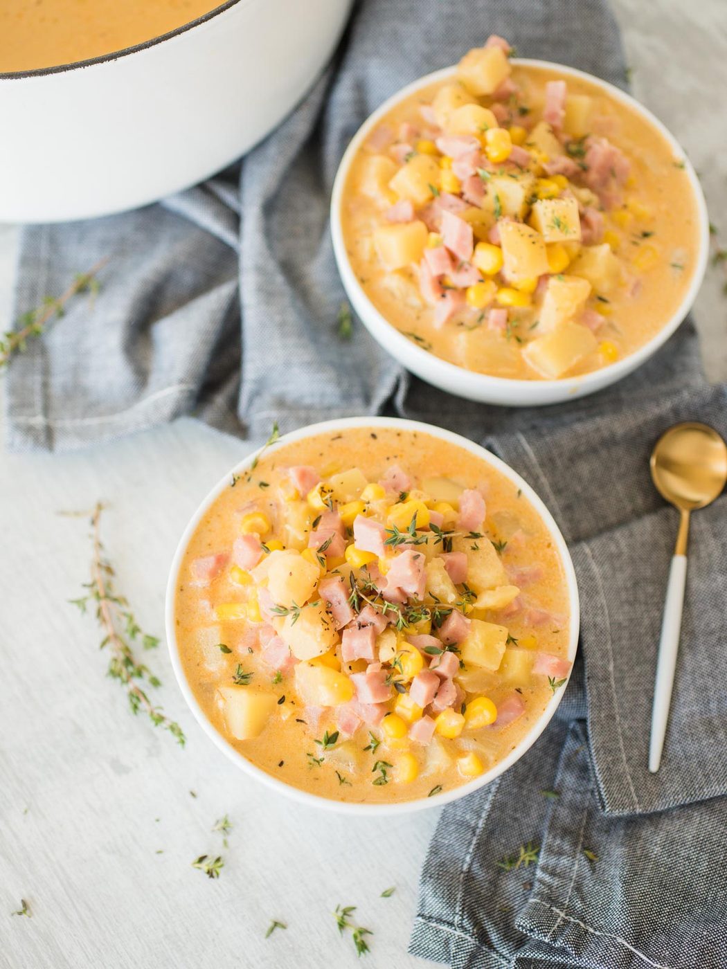two bowls of creamy ham and potato corn chowder