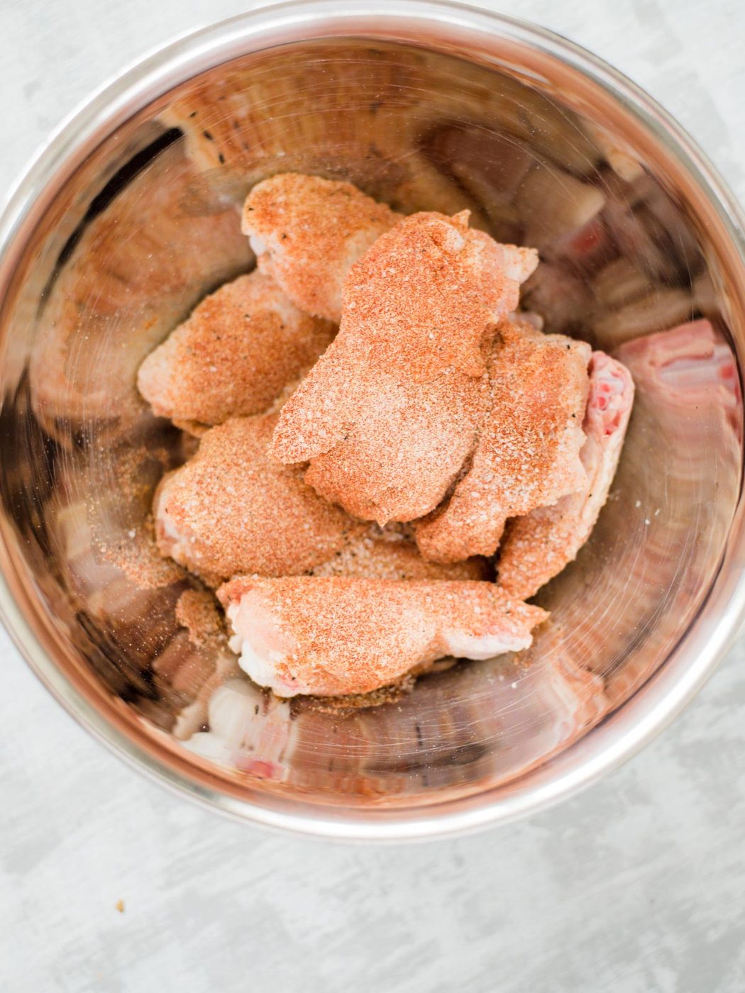 raw chicken wings with seasoning on them