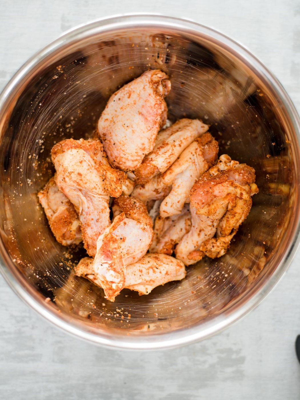 seasoned raw chicken wings in a bowl