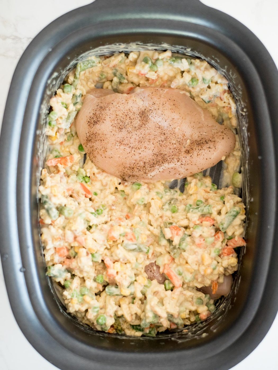 chicken breast added to the crockpot with the stuffing mix