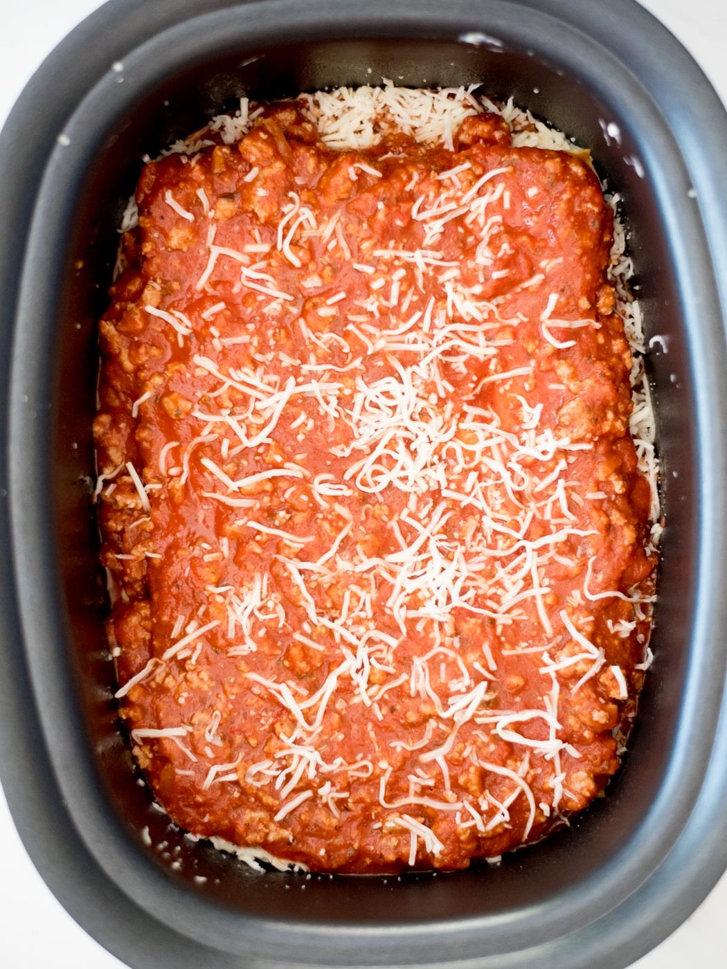 uncooked crockpot lasagna in the slow cooker
