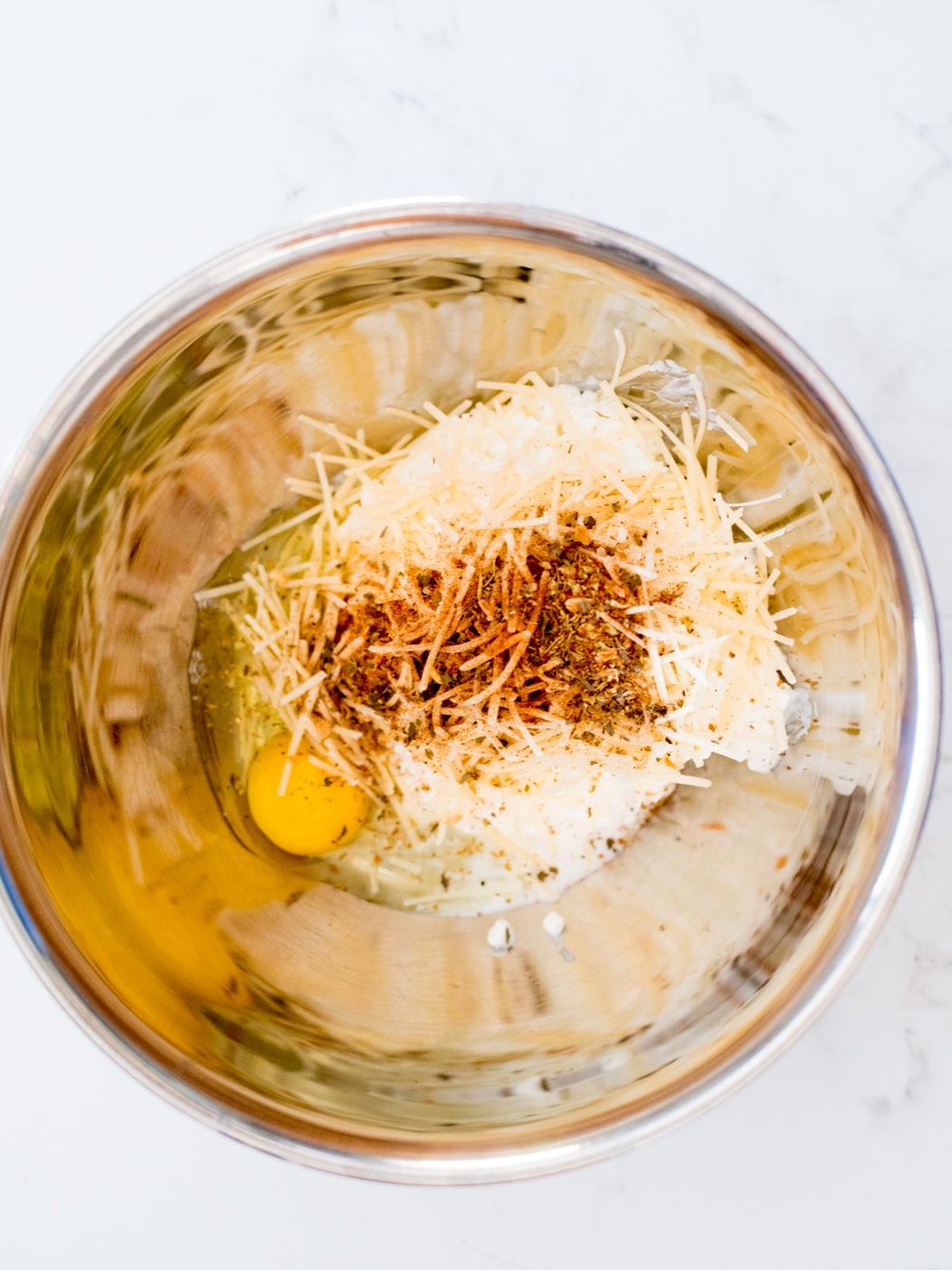 italian seasoning, egg, cottage cheese, and parmesan in a mixing bowl