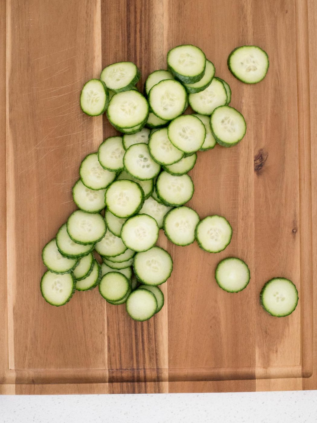 sliced cucumbers on a cutting board