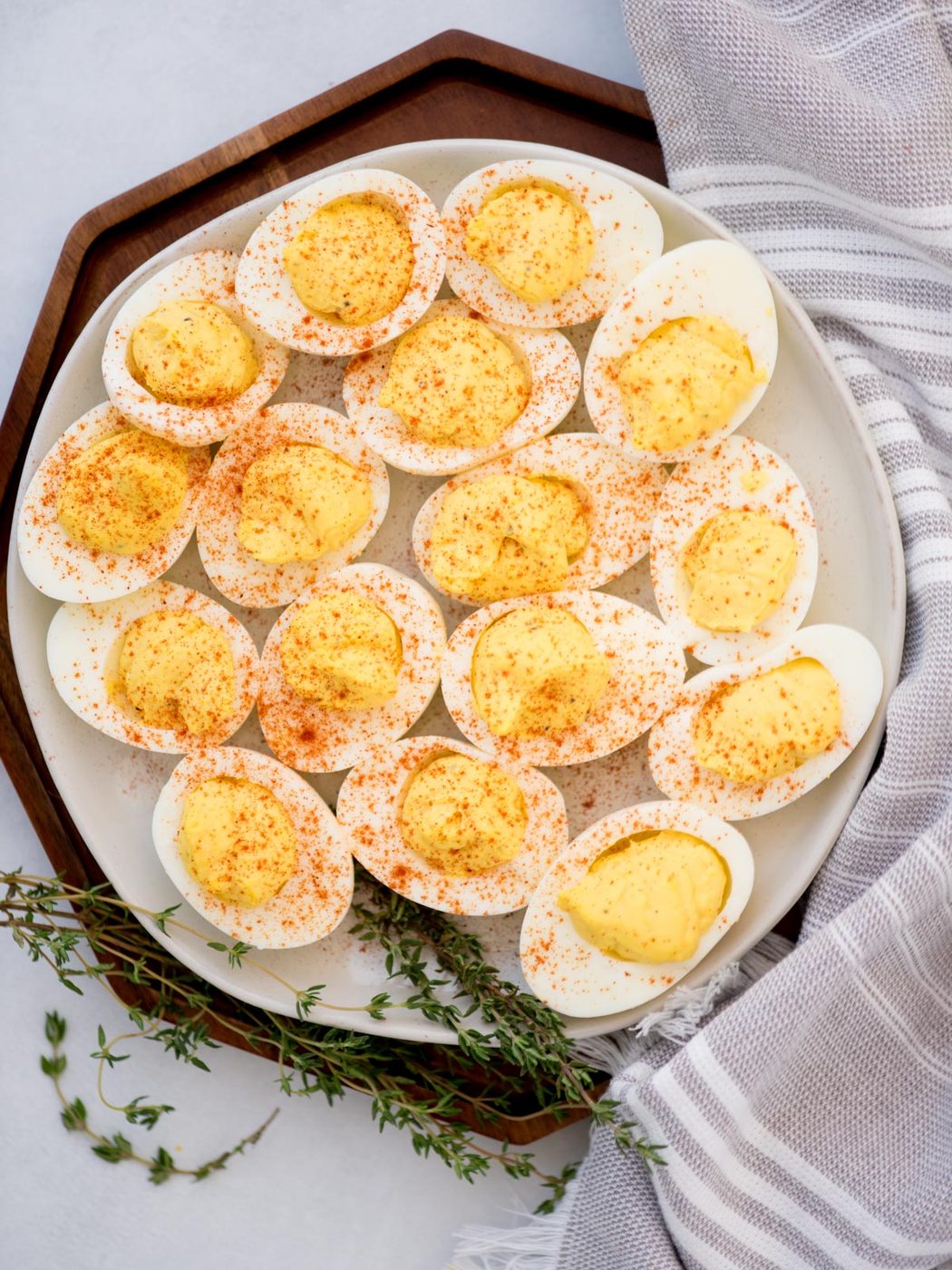 Top view of a platter filled with paprika sprinkled deviled eggs.