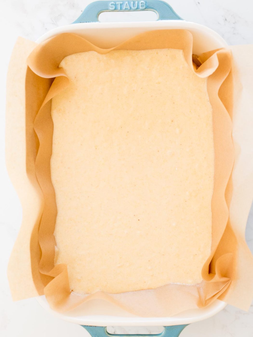 unbaked cornbread batter in a baking dish