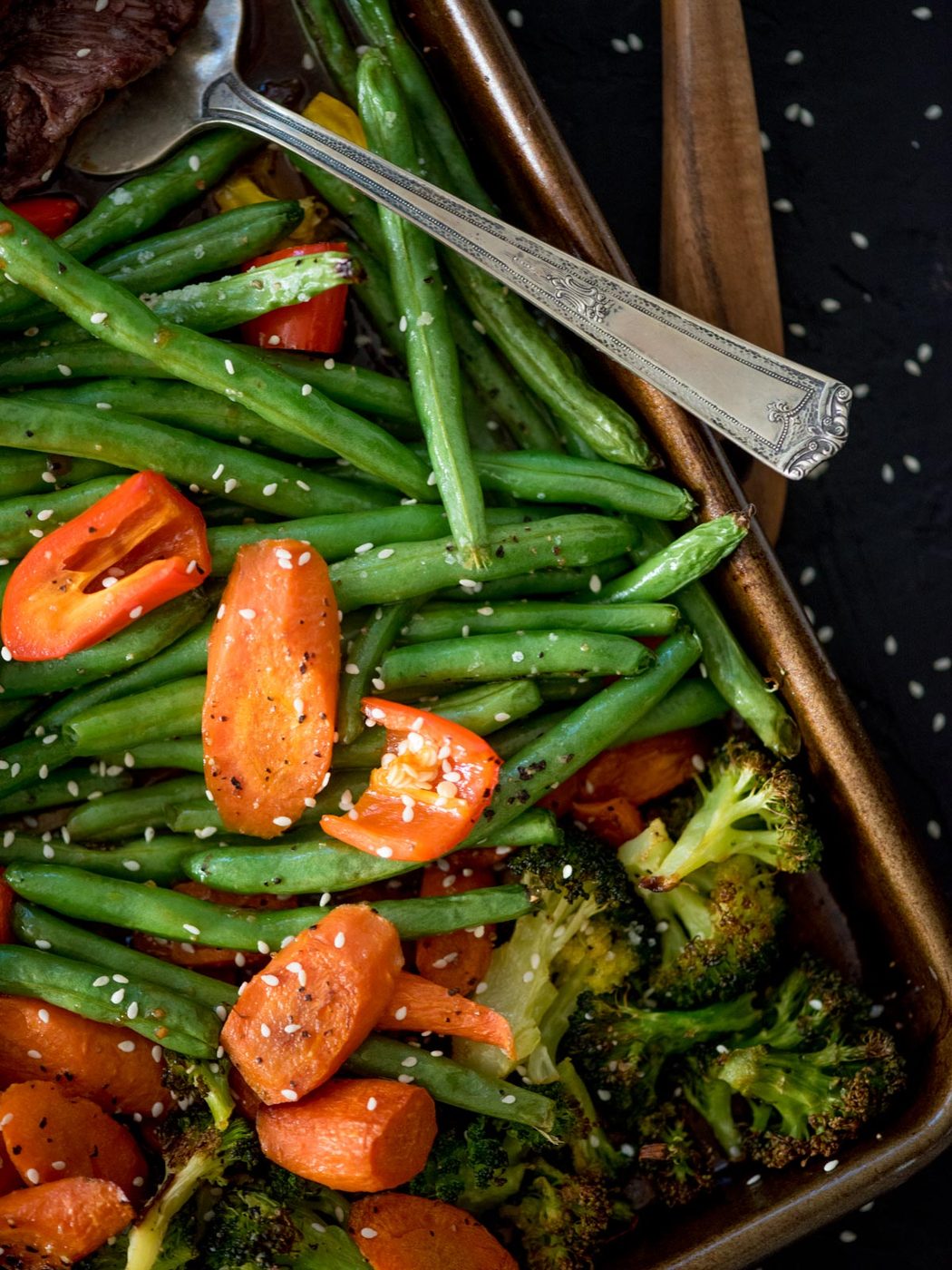 carrots, green beans and broccoli cooked on a sheet pan