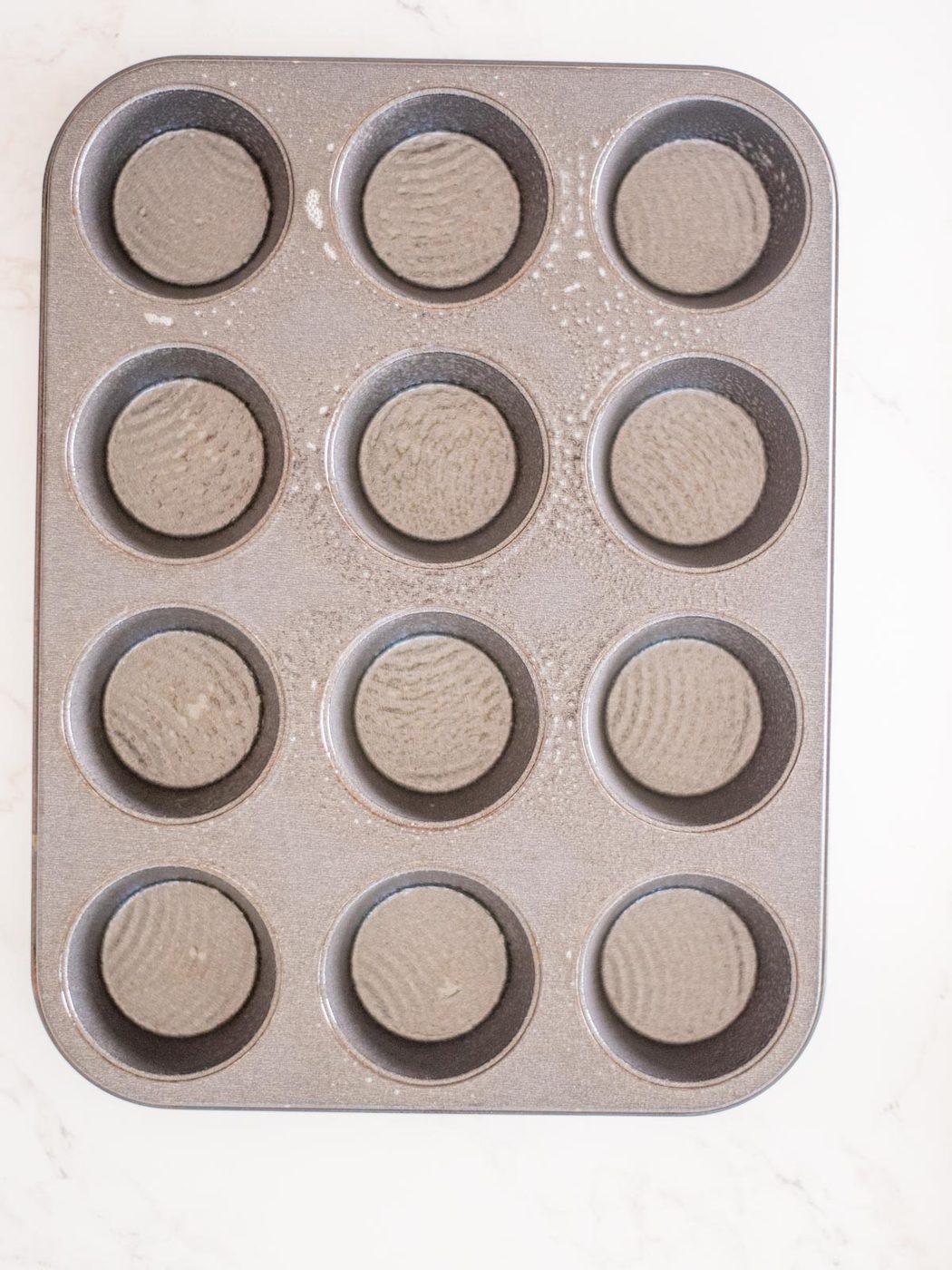 muffin tin sprayed with nonstick spray