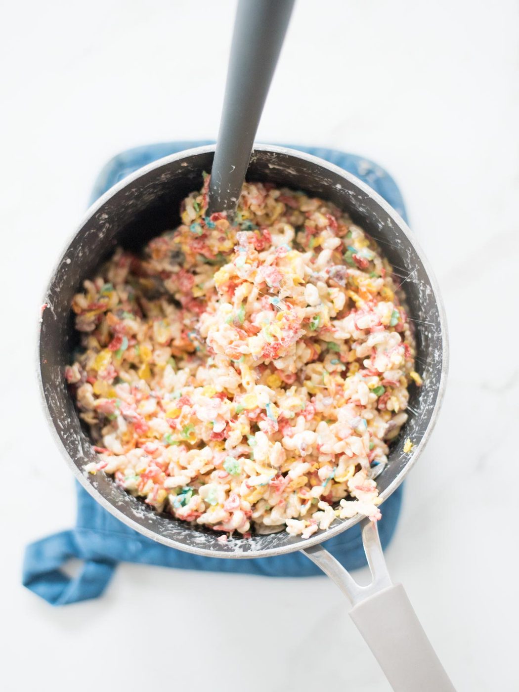 cereal mixed into the marshmallow mix in a saucepan