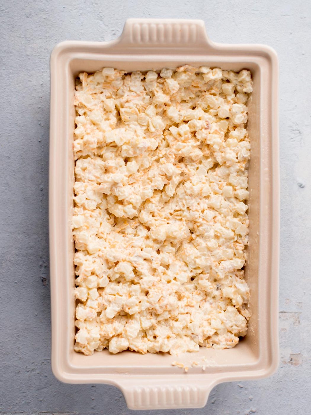 cheesy potato mixture added to the baking dish