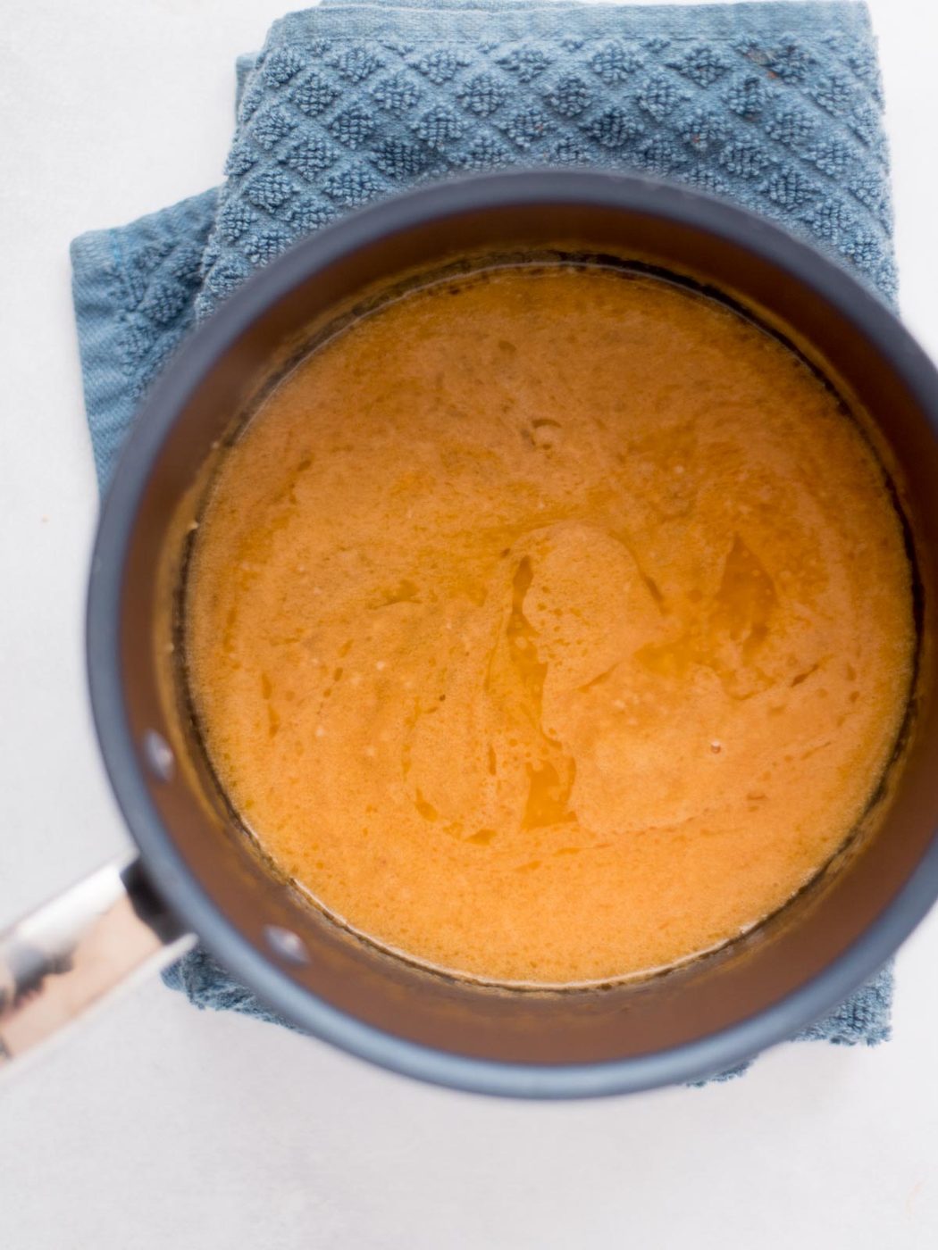 garlic butter wing sauce in a saucepan removed from the heat