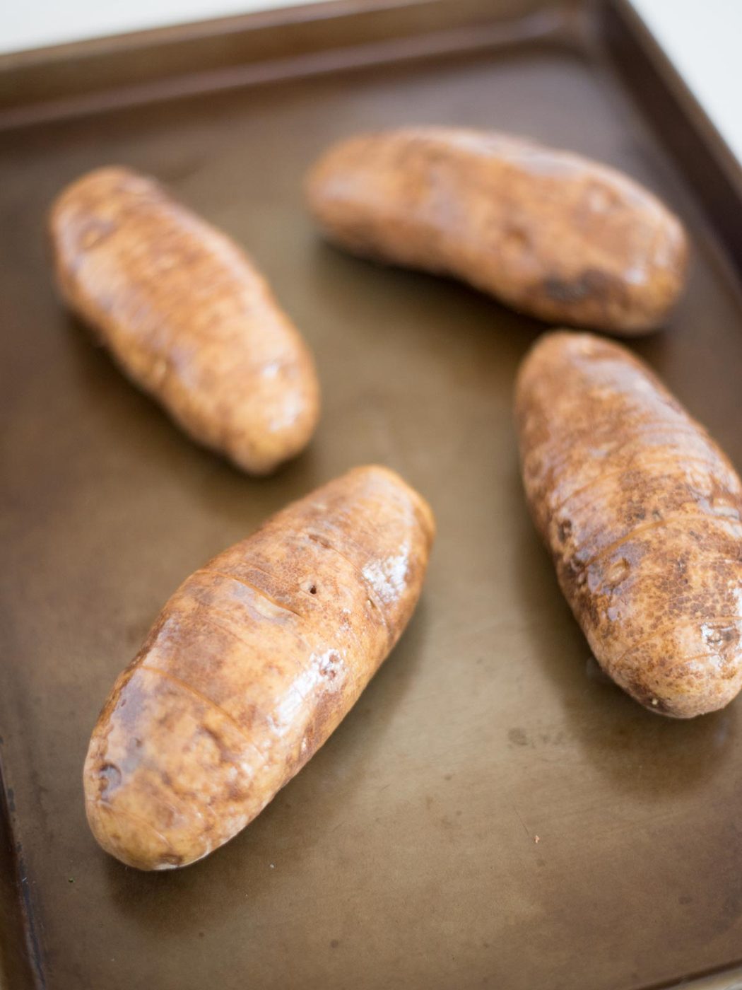 butter on sliced hasselback potato