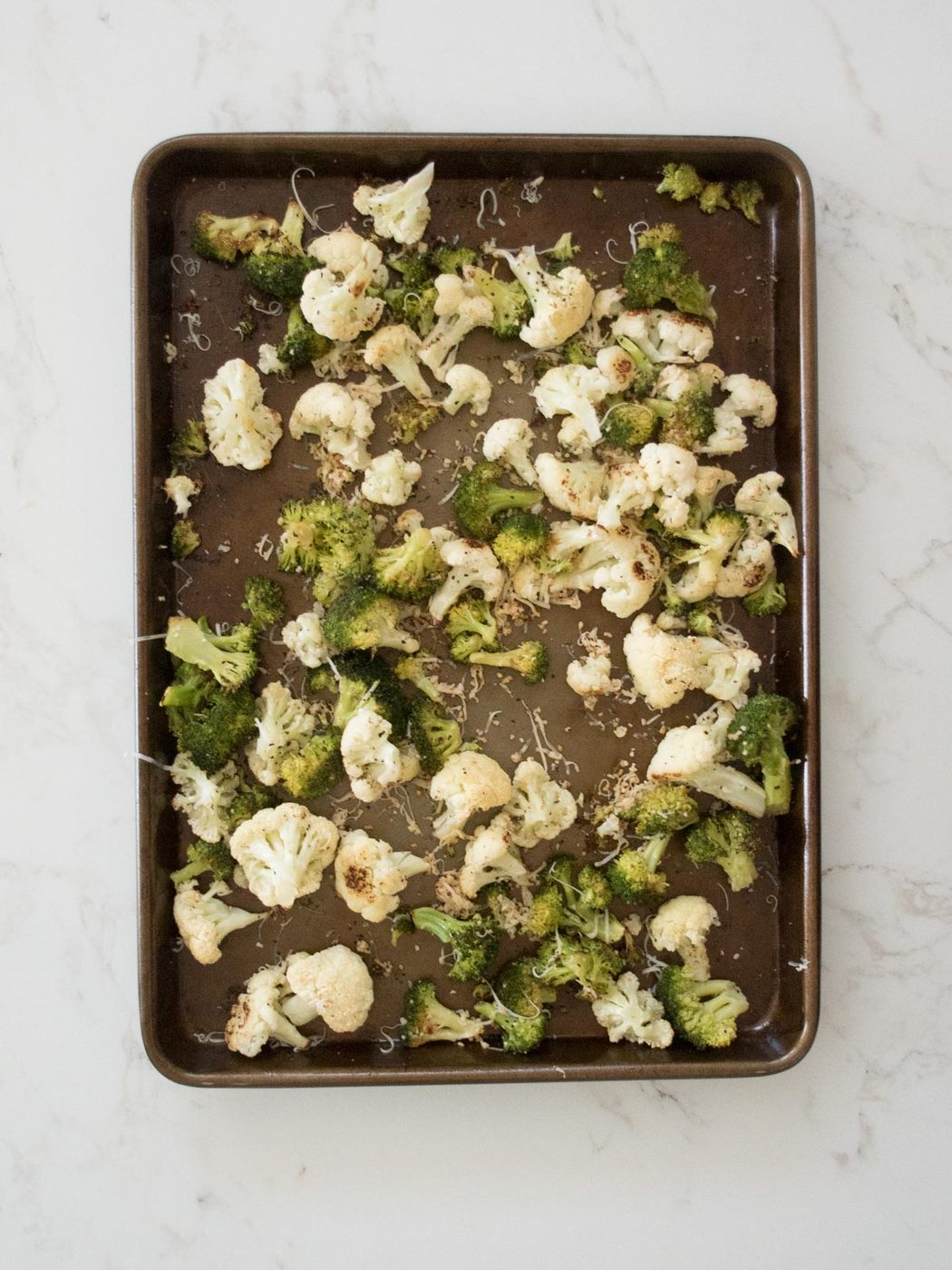 garlic parmesan roasted cauliflower and broccoli on a sheet pan