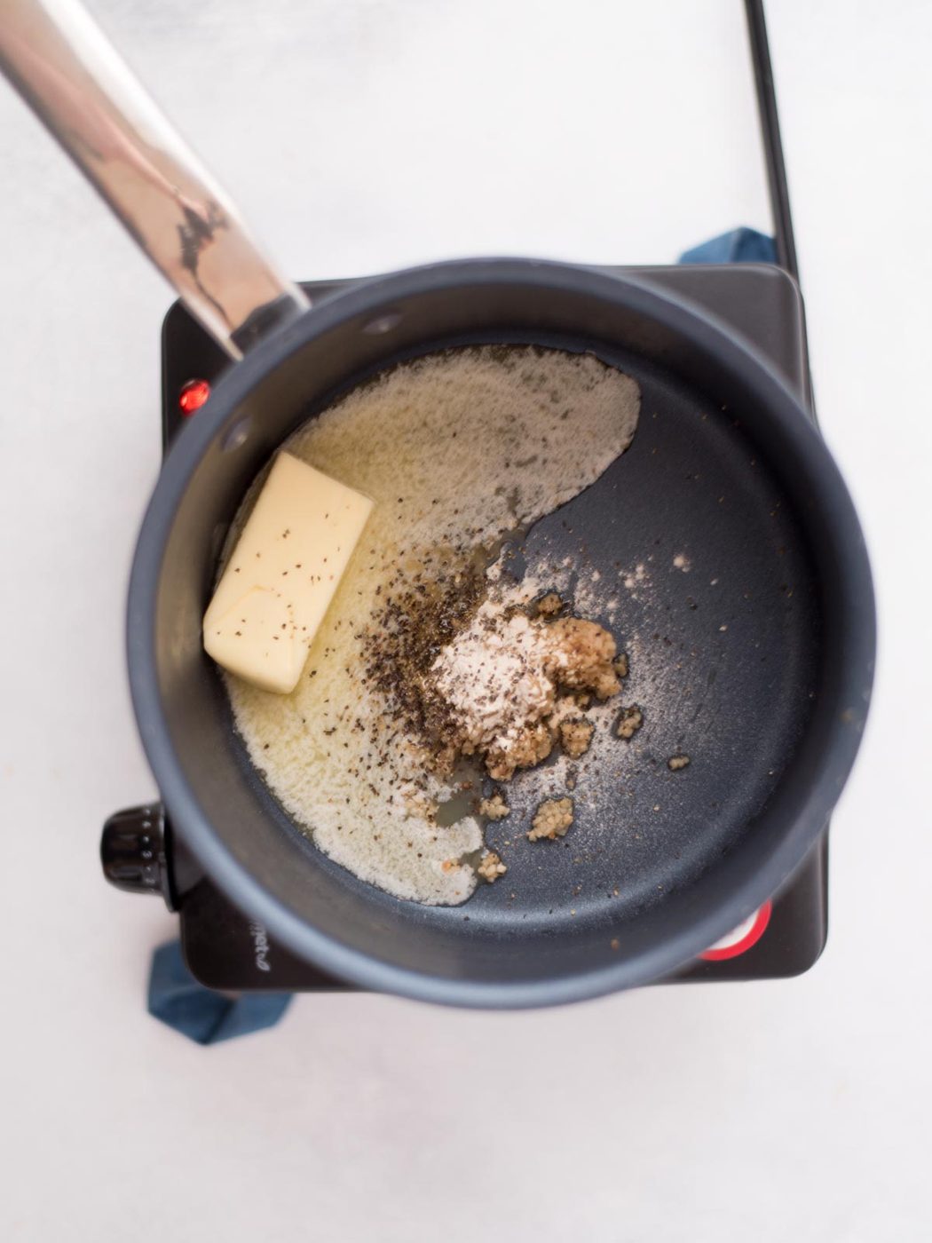 butter garlic onion powder and black pepper in a saucepan