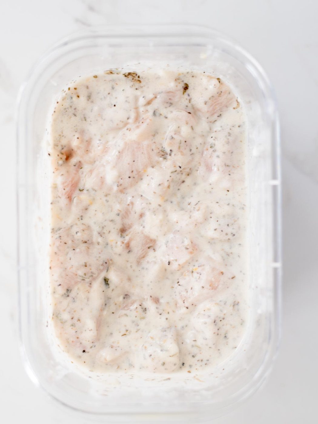 marinade and chicken mixed together in a bowl
