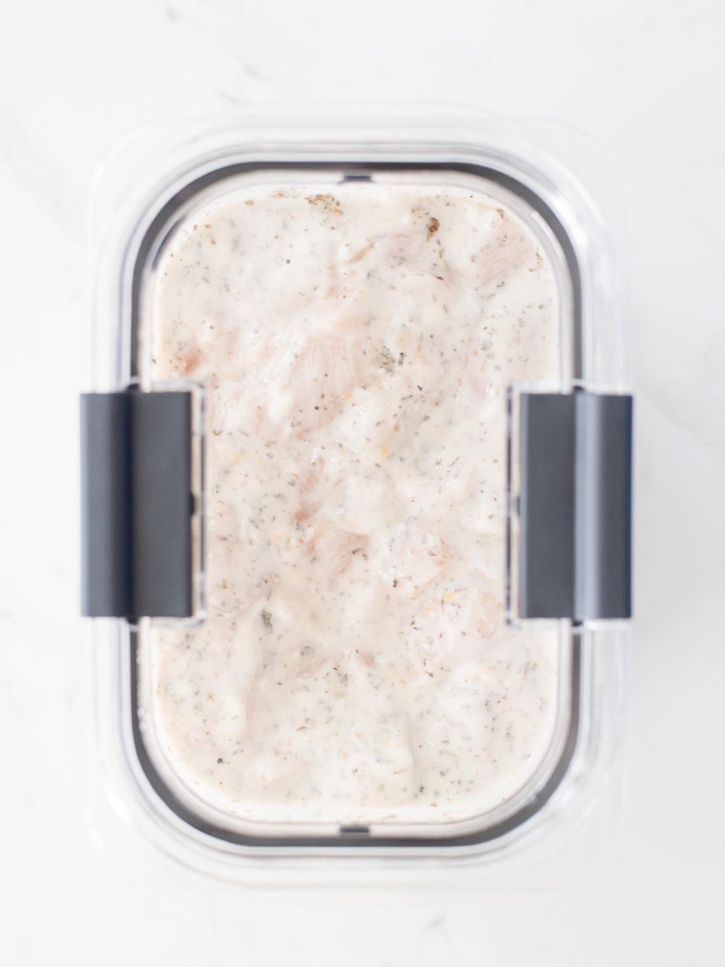 lid added to bowl with chicken and marinade