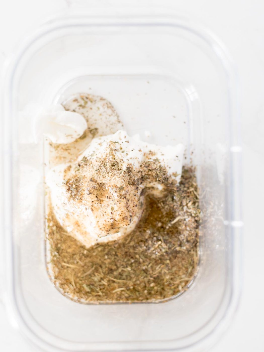olive oil, greek seasoning, and yogurt in a bowl