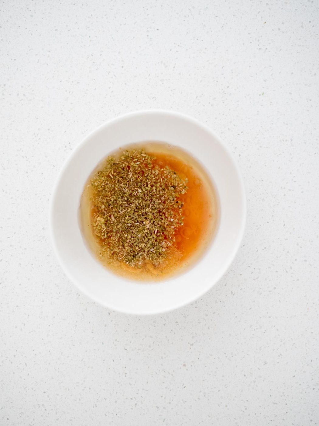 greek dressing ingredients in a bowl