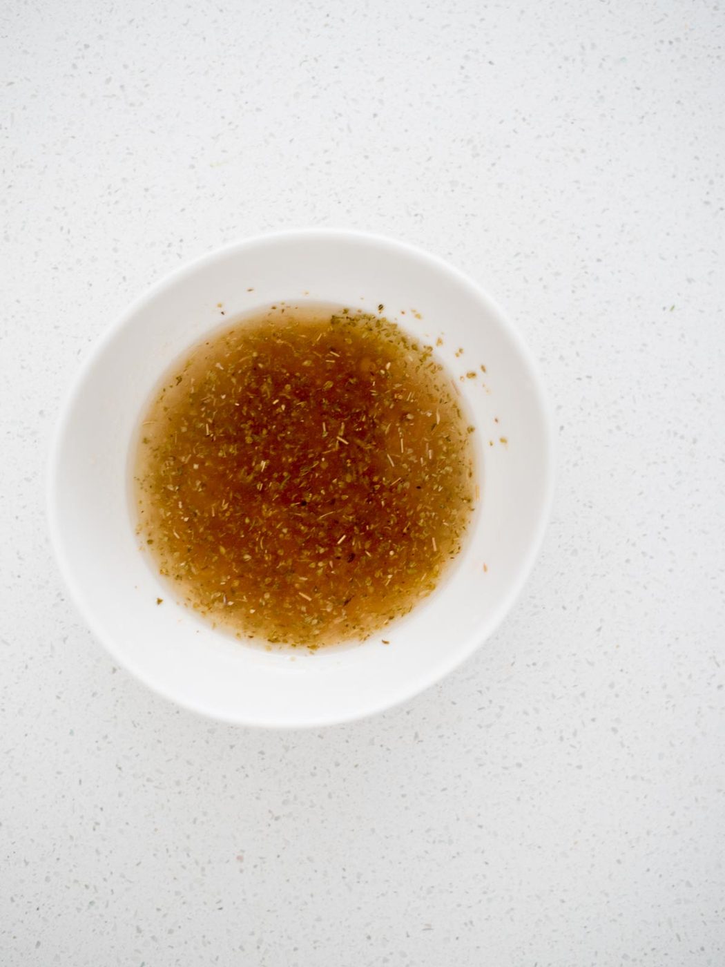 greek dressing mixed together in a small mixing bowl
