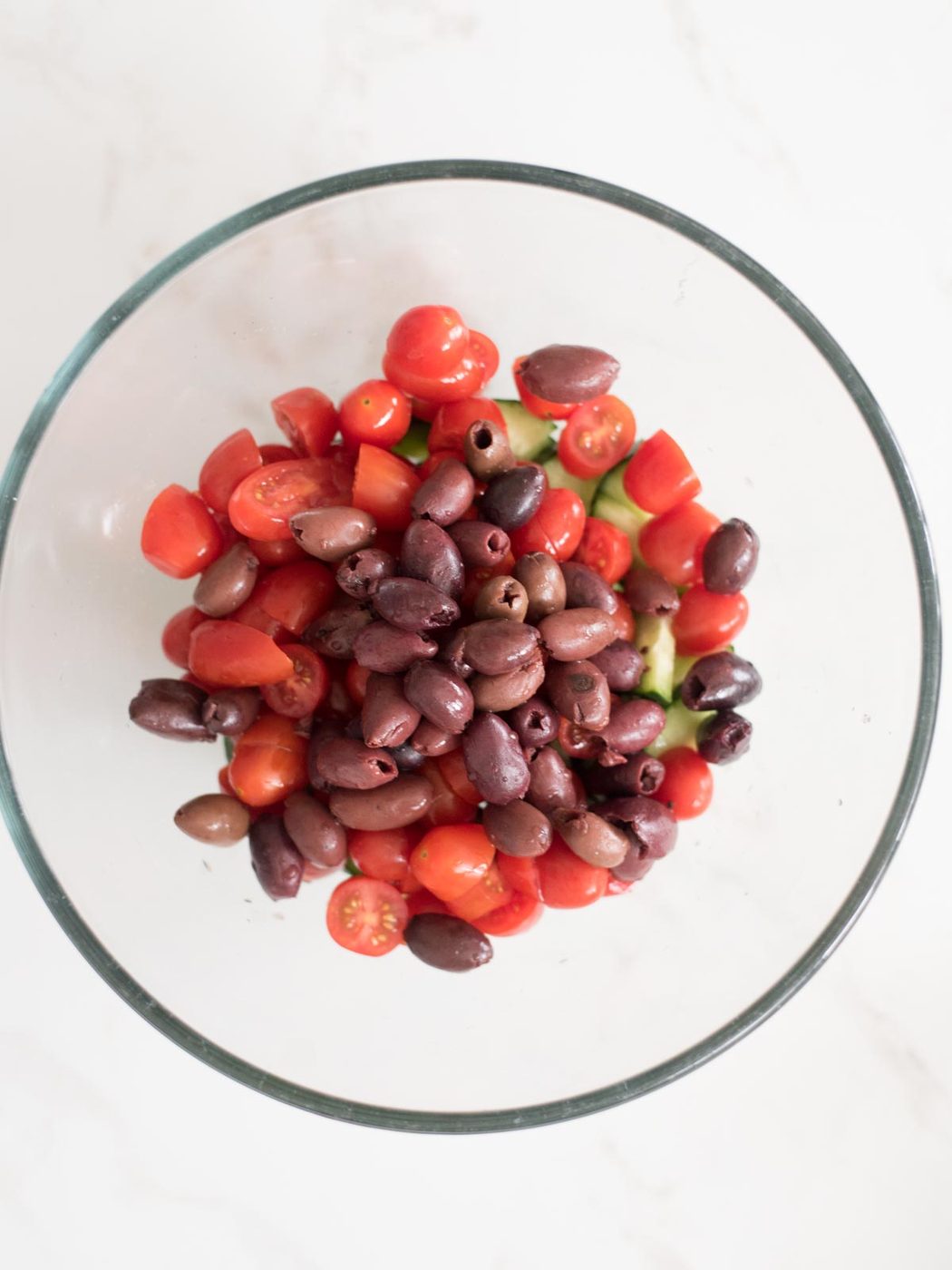 Kalamata olives added to mixing bowl