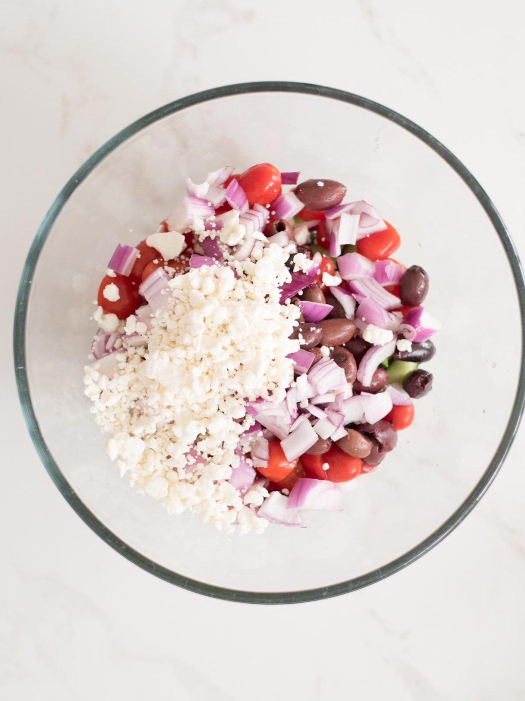crumbled feta added to mixing bowl