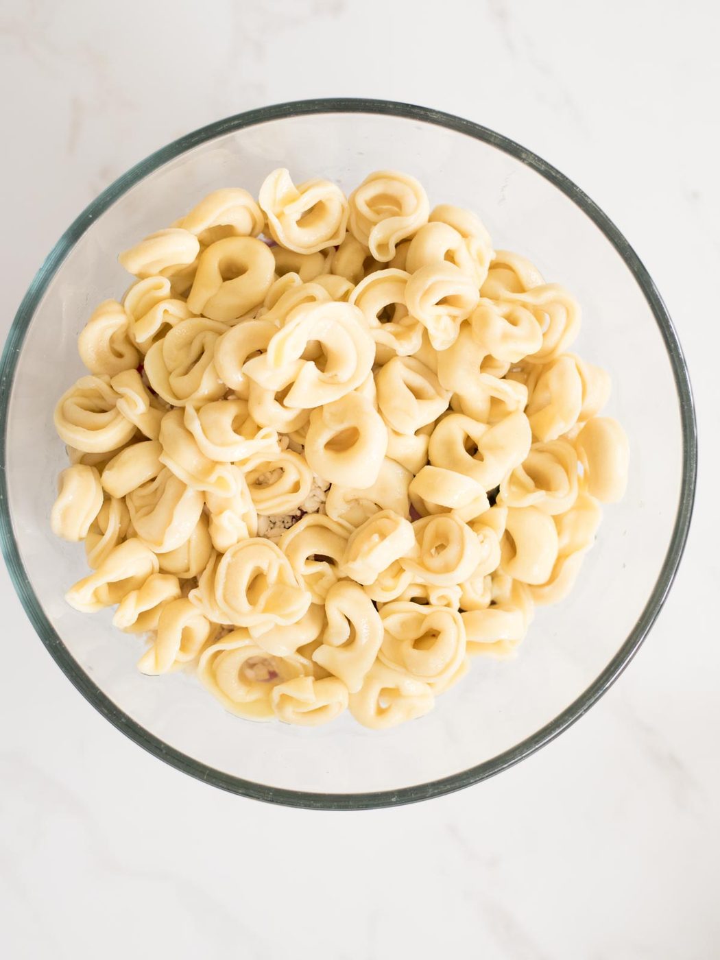 cooked tortellini added to mixing bowl