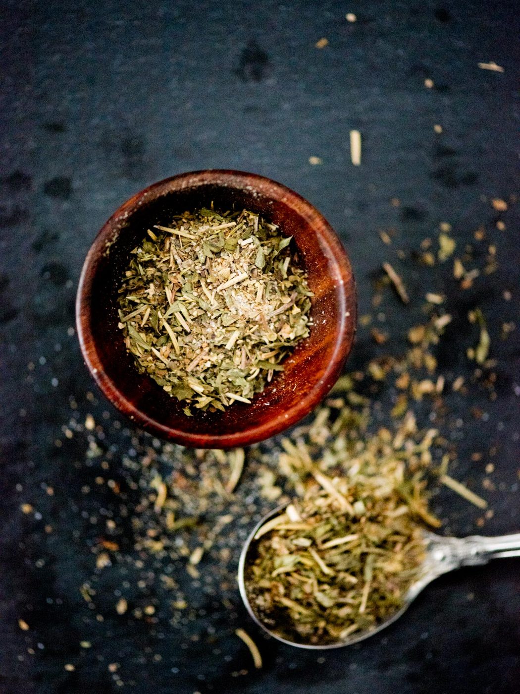 greek seasoning in a small pinch bowl and on a spoon