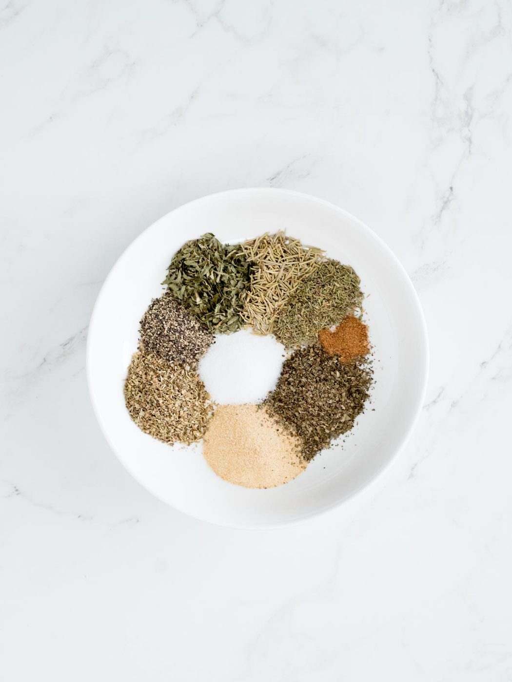dried herbs and spice ingredients for Greek seasoning recipe