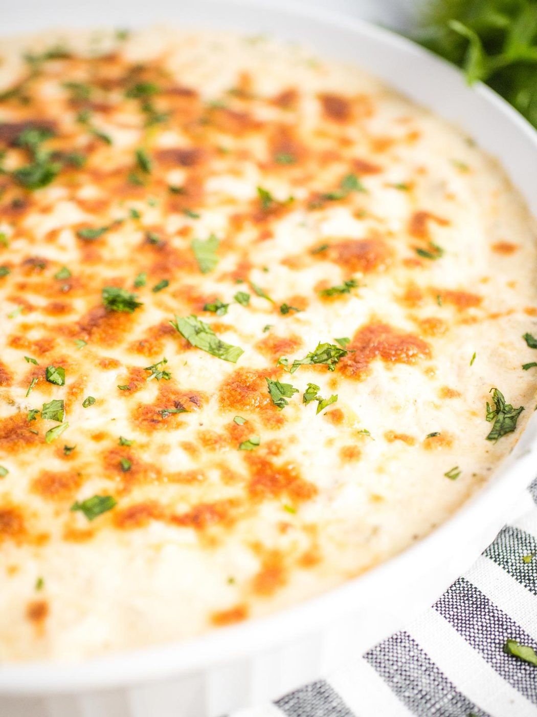 green chile queso blanco dip in a white dish