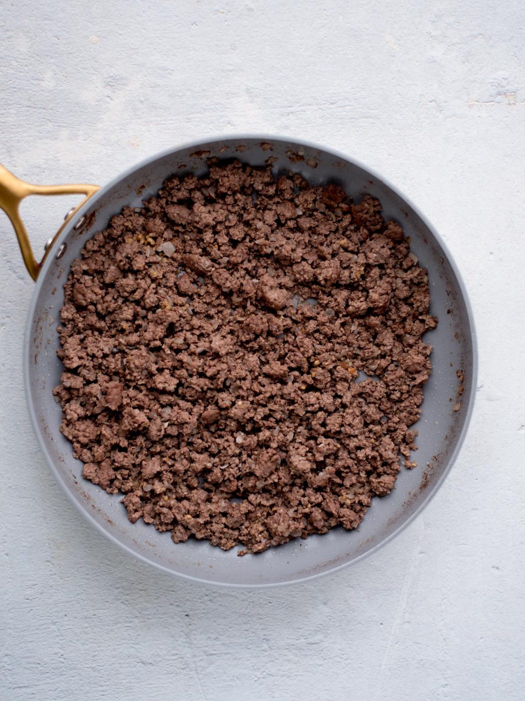 cooked ground beef in a skillet