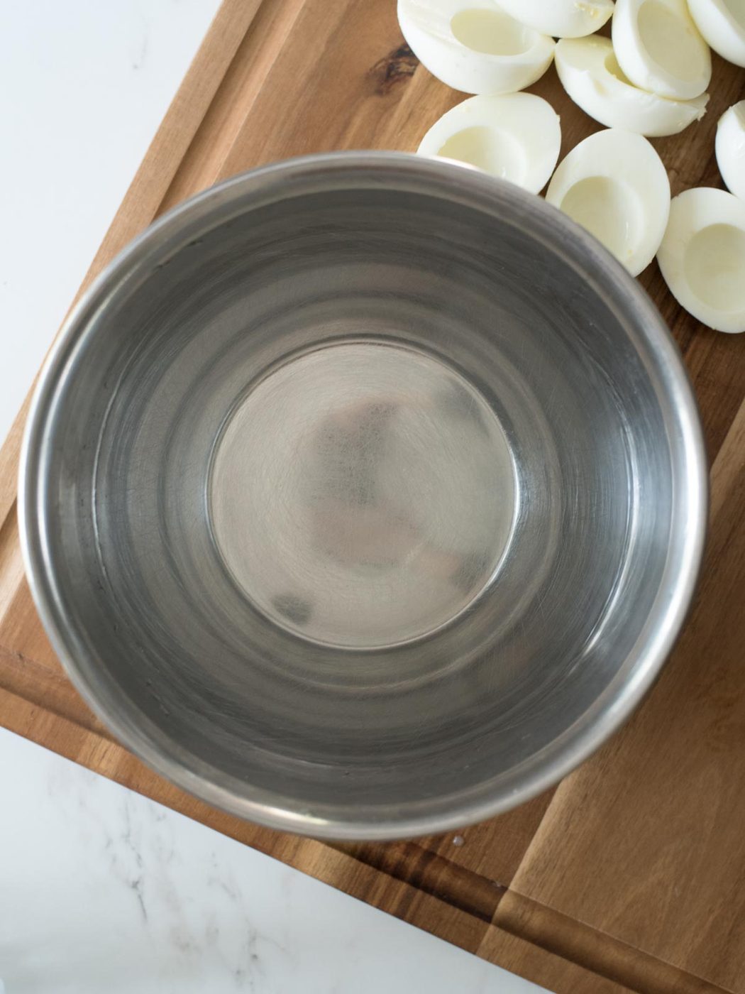 mixing bowl of water on a cutting board