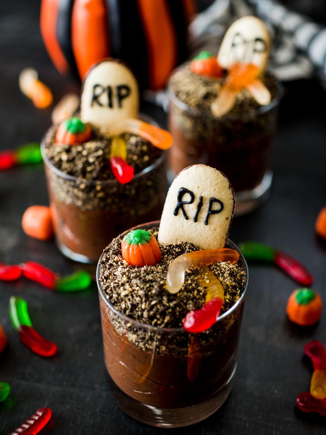 halloween graveyard dirt cups surrounded by toppings