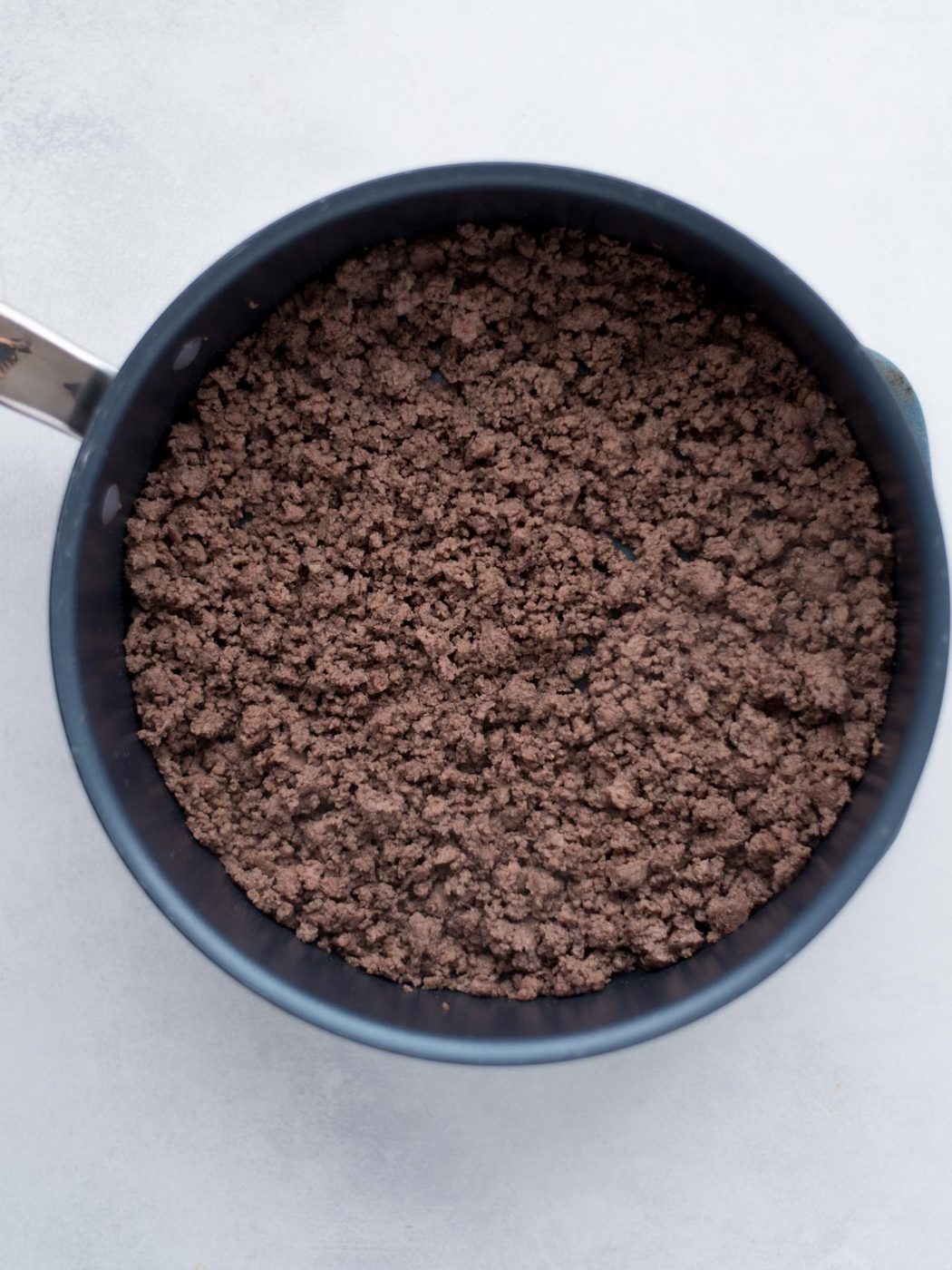 Seasoned ground beef in a skillet.