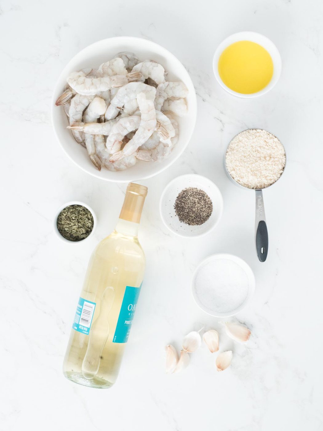 ingredients for baked shrimp scampi including raw shrimp garlic white wine butter and panko breadcrumbs