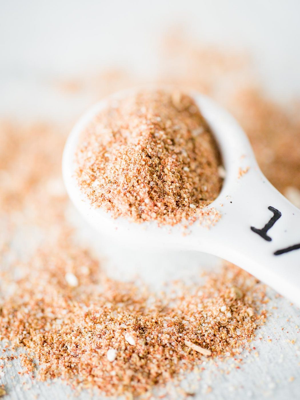 pile of taco seasoning on counter with a measuring spoon